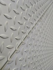 Laser cutting of stainless steel sheet, perforated steel for background.