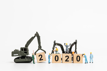 Miniature people : Worker team create wooden block number 2020  , Happy new year concept