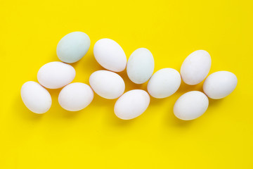 White eggs on yellow background.