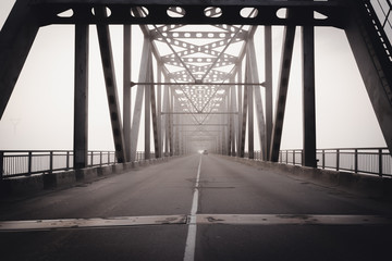 Bridge through Zeya river in a heavy fog