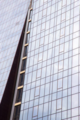  The facade of a modern office building made of glass and concrete..Vertically.