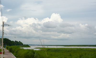 Beautiful Cloudscape with Clouds beside the river and walkways for people