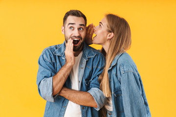 Image of happy woman whispering secret to excited man in his ear - obrazy, fototapety, plakaty