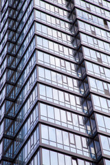 The facade of a modern office building made of glass and concrete..Vertically.