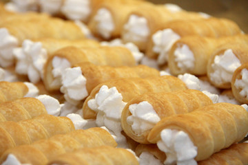 Stacked foam rolls or Schillerlocken Schaumrollen for sweet pastry
