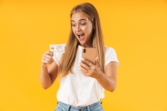 Image of happy woman smiling while holding smartphone and credit card
