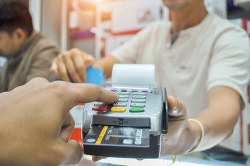 Hand of customer paying with  credit card.