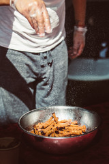 Man salt garlic croutons snacks  in metalic bowl. Vertical image.