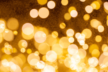 Christmas and Happy new year on blurred gold bokeh banner background.