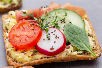 Sandwiches with cream cheese, vegetables and salami.