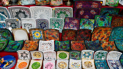 Colorful mosaic decorative plates on the market for sale on local street market.