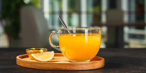 tea, honey, lemon and sea buckthorn (aromatic mustard drink in a cafe restaurant) menu concept. food background. copy space. Top view