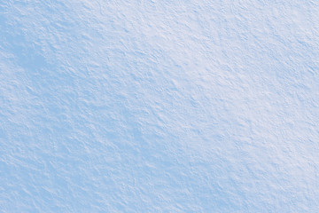 Snow covered field texture. Abstract winter background in blue tones, top view from drone