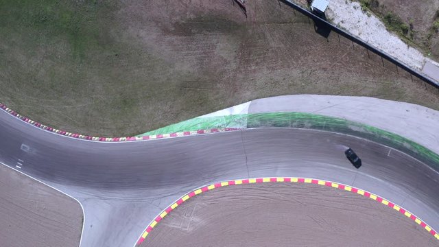 Top view car drifting with smoke from wheels on racing track. Racing jdm drift car with burning tires on speed track. Car racer drifting car on asphalt track