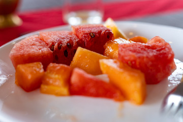 Watermelon and papaya served in a white plate