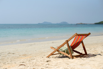 Chaise lounge on the tropical beach at sunny summer day. Travel vacation relax concept. Free copy...