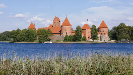 Fototapeta premium The famous Trakai Island Castle in Lithuania in a blue sky day and calm lake