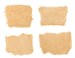 Set of small torn pieces of cardboard paper on white background. Can be used for text.