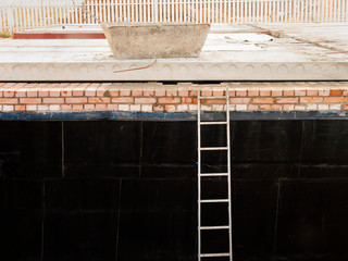 Ladder leaning against the basement wall
