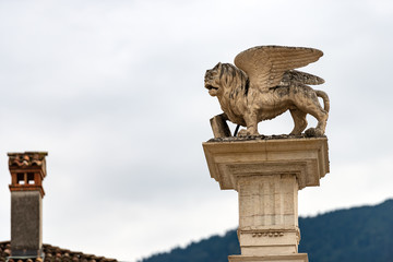 Winged lion of St Mark (Leone di San Marco) on the top of a column, symbol of the Venetian Republic. Piazza Maggiore, Feltre, Belluno province, Veneto, Italy, south Europe