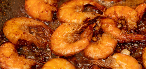 Shrimp fried in a pan in oil