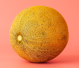 Ripe tasty melon on a pink background