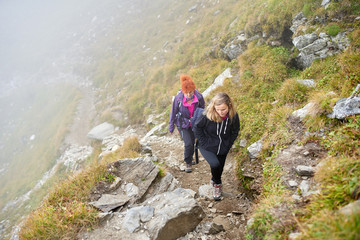 Backpacker ladies hiking on a trail