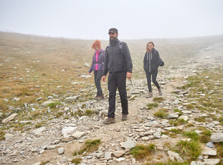 People with backpacks hiking into the mountains