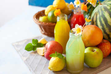 Fresh fruit, berry and vegetable juices on bright blue background.Homemade refreshing beverage