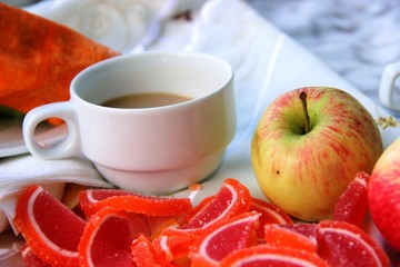 one yellow red Apple, lots colorful Apple marmalade slices, classic white c Cup and saucer. mini picnic in the Park