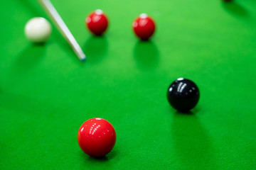 Snooker balls on the green table for playing entertainment of man.