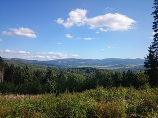 Summer landscape in mountains and the dark blue sky with clouds