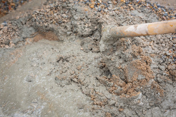 Construction technicians are mixing cement, stone, sand for construction.