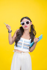 Beautiful female students hold notebooks and pens in the hands of creative designs on a yellow background.