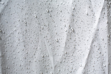 Wet white wrinkled shower curtain with water drops, steam shower on white background, Light and...