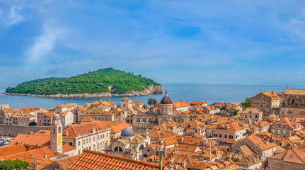 Fototapeta na wymiar High angle view of the Old Town in Dubrovnik, with green Lokrum Island in the Adriatic Sea.