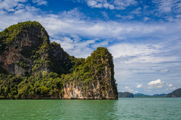 Fototapeta na wymiar Thailand. Near Phuket. Cliffs of the Andaman Sea. Traveling in Thailand. Holidays in Thailand. Rocky coast in the middle of the sea. Walk on the ocean. Middle East Asia. Green cliff.