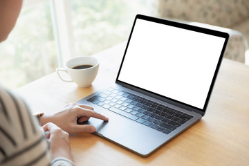 Fototapeta premium Women using laptop with blank screen at table in the office.