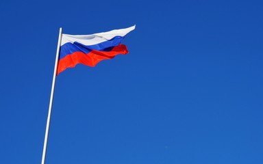 Russian Federation flag against blue sky, copy space