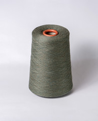 bobbin of yarn on a white background. Side view.Textile reel on isolated white background.