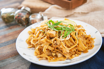 Pad Thai, vegan recipe made with rice noodles, vegetables and peanuts cooked on wok