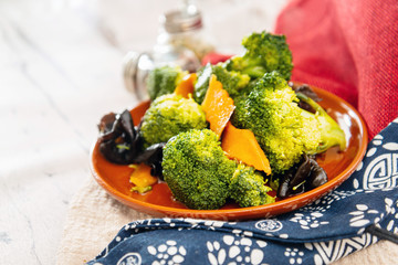 Mixture of vegetables cooked with broccoli and black mushrooms served in a plate for eating