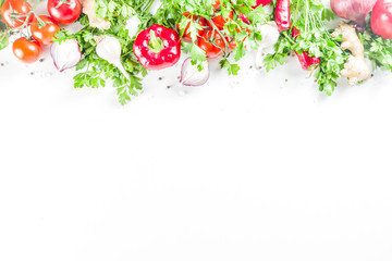 Cooking background with fresh vegetables and herbs. Healthy clean eating vegetarian food, diet nutrition concept. Various fresh veggie ingredients for salad or stew, white table, top view copy space