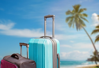 Composition with two suitcases on the background of tropic beach