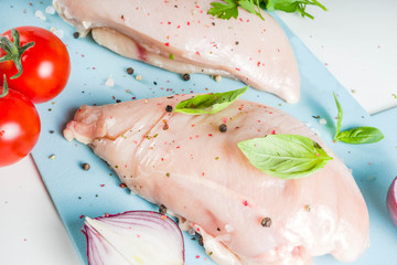Raw chicken fillet with spices and herbs on cutting board. Cooking chicken breast background. Preparation food, Diet healthy meat.