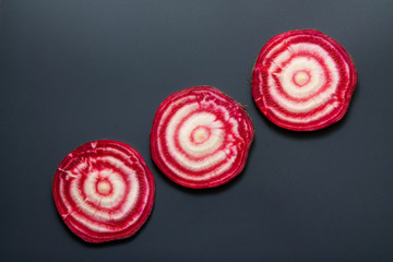 Sliced raw ​​beetroot on black background