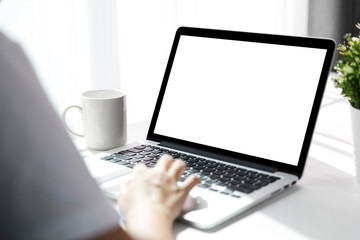 Women using laptop with blank screen at table in the office, Back view of business women hands busy using laptop at office desk.