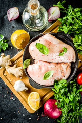 Raw chicken fillet with spices and herbs on cutting board. Cooking chicken breast background. Preparation food, Diet healthy meat.