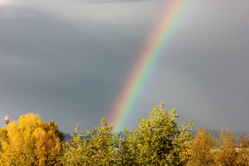rainbow after rain against a stormy sky