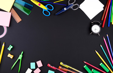 school supplies: multicolored wooden pencils, notebook, paper stickers, paper clips, pencil sharpener